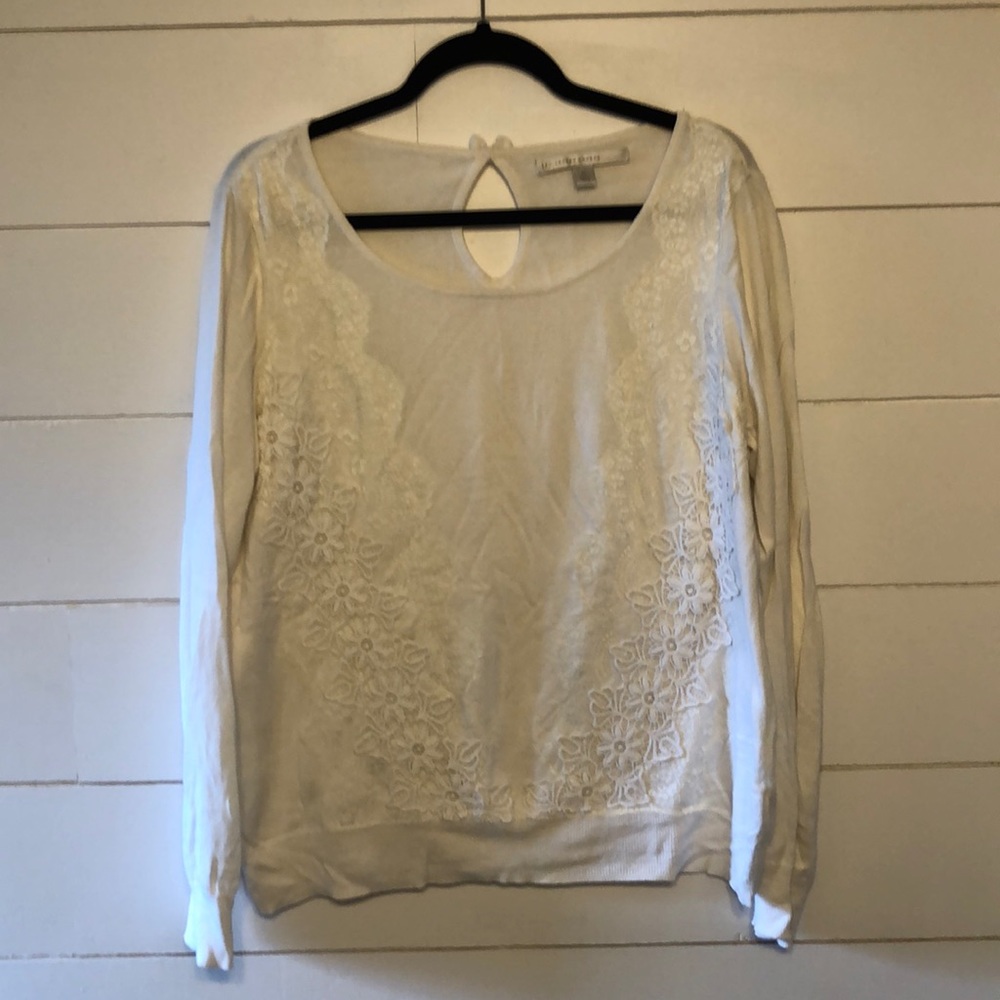 White sweater with lace details.